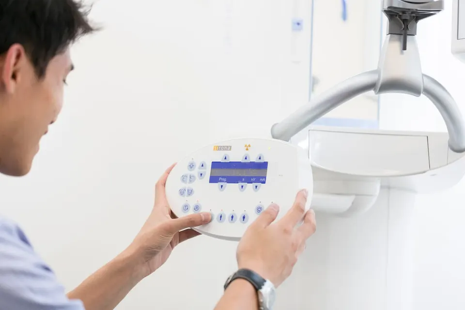 Dentist using dental equipment during an assessment